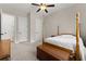 Bedroom featuring carpet flooring, a wooden bed frame, and two entry doors at 6625 Baywood Run, Cumming, GA 30041