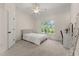 Bright, carpeted bedroom features a ceiling fan and a window overlooking trees at 6625 Baywood Run, Cumming, GA 30041