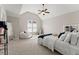 Serene bedroom featuring vaulted ceilings, cozy seating, and ample natural light at 6625 Baywood Run, Cumming, GA 30041