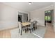 Light-filled dining room featuring a long wooden table set for six, set against a wall with wainscotting at 6625 Baywood Run, Cumming, GA 30041