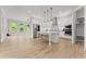 Bright and airy white kitchen featuring stainless appliances, center island, hardwood floors, and adjacent breakfast area at 6625 Baywood Run, Cumming, GA 30041