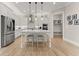Modern kitchen with stainless appliances, white cabinets, center island, and adjacent breakfast area and mudroom at 6625 Baywood Run, Cumming, GA 30041