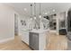 Bright kitchen featuring a white island with marble countertops and stainless steel appliances at 6625 Baywood Run, Cumming, GA 30041