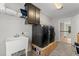 Well-lit laundry room with front loading washer and dryer set, utility sink, and storage at 6625 Baywood Run, Cumming, GA 30041