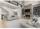 Spacious living room with stone fireplace, built-in shelving, soaring ceilings, and hardwood floors at 6625 Baywood Run, Cumming, GA 30041