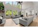 Bright and airy living room with soaring windows, hardwood floors, stone fireplace and adjacent open kitchen at 6625 Baywood Run, Cumming, GA 30041