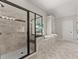 Bright bathroom boasting a tiled shower, soaking tub, and large windows at 6625 Baywood Run, Cumming, GA 30041
