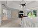 Comfortable main bedroom featuring a fireplace and large windows offering outdoor views at 6625 Baywood Run, Cumming, GA 30041