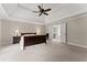 Spacious main bedroom featuring a tray ceiling, ceiling fan, and neutral decor at 6625 Baywood Run, Cumming, GA 30041