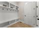 Bright mudroom featuring built-in shelving, a bench, and convenient hooks for storage at 6625 Baywood Run, Cumming, GA 30041