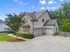 Beautiful home showcasing brick accents and a three-car garage with plenty of parking space at 6625 Baywood Run, Cumming, GA 30041