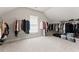 Large walk-in closet with ample hanging space and neutral carpeting at 6625 Baywood Run, Cumming, GA 30041