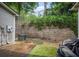 Cozy backyard featuring a brick wall, small grass patch, and gray siding of the home at 780 Nehemiah Sw Ln, Atlanta, GA 30331