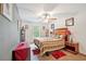 Comfortable bedroom features a ceiling fan, window, night stand, and neutral walls at 780 Nehemiah Sw Ln, Atlanta, GA 30331