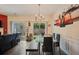 Bright dining area features modern lighting, glass table, and access to the outdoor patio at 780 Nehemiah Sw Ln, Atlanta, GA 30331