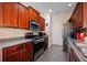 A cozy kitchen featuring sleek countertops, stainless steel appliances, and dark wood cabinetry at 780 Nehemiah Sw Ln, Atlanta, GA 30331