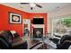 A modern living room featuring a fireplace, comfortable seating, and a sliding door to the backyard at 780 Nehemiah Sw Ln, Atlanta, GA 30331