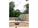 Backyard featuring hanging chair with modern concrete block wall and a cozy fire pit area at 1195 Russell Dr, Decatur, GA 30030
