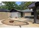 Home exterior showcasing a backyard patio with gravel firepit and concrete decorative block wall at 1195 Russell Dr, Decatur, GA 30030
