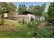 Expansive backyard featuring stone accents, lush greenery, and a chicken foraging, perfect for nature lovers at 1195 Russell Dr, Decatur, GA 30030