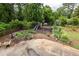 Spacious backyard featuring a playset, raised garden beds, and mature landscaping, ideal for outdoor activities at 1195 Russell Dr, Decatur, GA 30030