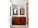 Bright bathroom featuring a double vanity with wood cabinets and granite countertop at 1195 Russell Dr, Decatur, GA 30030