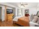 Bright main bedroom features wood floors, large dresser, and ensuite bathroom at 1195 Russell Dr, Decatur, GA 30030