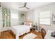 Bright bedroom with wood floors, decorated with modern botanical prints, a ceiling fan and natural lighting at 1195 Russell Dr, Decatur, GA 30030