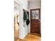 Charming entryway featuring a rustic wood door, bright white brick, and stylish storage hooks at 1195 Russell Dr, Decatur, GA 30030