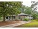 Lovely single-story home with brick facade, well-maintained lawn, and a charming outdoor seating area at 1195 Russell Dr, Decatur, GA 30030