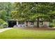 Charming single-story home features a mature tree and a well-manicured front lawn at 1195 Russell Dr, Decatur, GA 30030