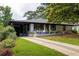 Charming single-story home with a well-manicured lawn, inviting front porch, and beautiful landscaping at 1195 Russell Dr, Decatur, GA 30030
