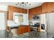 Well-lit kitchen with stainless steel appliances, granite countertops, and wooden cabinetry at 1195 Russell Dr, Decatur, GA 30030