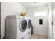 Bright laundry room featuring a modern washer and dryer with tile flooring at 1195 Russell Dr, Decatur, GA 30030