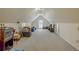 This attic offers ample storage space with a vaulted ceiling, featuring carpeting and a small window for natural light at 160 Vinnys Way, Covington, GA 30014