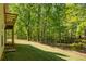 Scenic backyard with mature trees and lush lawn, complemented by architectural details of the home's exterior at 160 Vinnys Way, Covington, GA 30014