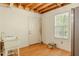 Unfinished basement featuring a utility sink, white door, and window that offers natural light at 160 Vinnys Way, Covington, GA 30014