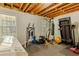 Basement featuring fitness equipment including a treadmill, punching bag, weight bench and exercise machine at 160 Vinnys Way, Covington, GA 30014