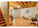 This basement offers a versatile space with exposed ceiling beams and light wood flooring, and convenient staircase access at 160 Vinnys Way, Covington, GA 30014