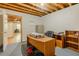 Basement office features a desk, chair, shelving, and unfinished ceiling, and is partially staged at 160 Vinnys Way, Covington, GA 30014