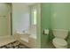 Relaxing bathroom features a soaking tub, toilet, and tiled flooring at 160 Vinnys Way, Covington, GA 30014