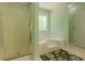 Inviting bathroom showcasing a soaking tub, glass shower, and neutral finishes at 160 Vinnys Way, Covington, GA 30014