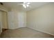 This bedroom features neutral carpeting and multiple doors, with ample space and a ceiling fan at 160 Vinnys Way, Covington, GA 30014