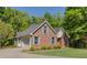 View of brick home with attached garage and well-maintained landscaping at 160 Vinnys Way, Covington, GA 30014
