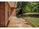 Side of home featuring wooden deck and landscaped garden beds at 160 Vinnys Way, Covington, GA 30014