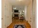 Inviting foyer featuring hardwood floors, decorative rug, and a view into the living room with a fireplace at 160 Vinnys Way, Covington, GA 30014
