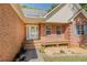 Close-up of front porch with decorative door and meticulous landscaping at 160 Vinnys Way, Covington, GA 30014
