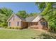Charming brick home with lush green lawn, mature trees, and inviting front porch at 160 Vinnys Way, Covington, GA 30014