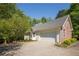 Side view of home featuring an attached two-car garage and well-manicured lawn at 160 Vinnys Way, Covington, GA 30014