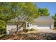 Home exterior showcasing an attached two-car garage and partially shaded driveway at 160 Vinnys Way, Covington, GA 30014